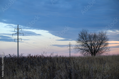 Power lines at sunset in a autumn landscape