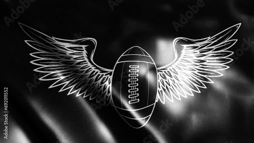 flag in loop of american football and wing silhouette in black background
