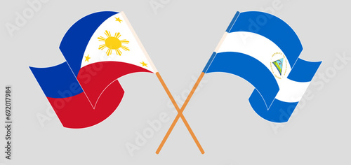 Crossed and waving flags of the Philippines and Nicaragua