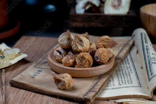 Dried figs and ancient books on the desktop