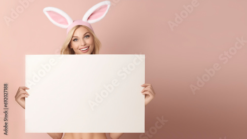 Beautiful young model holding a large blank sign with plenty of room for copy and text