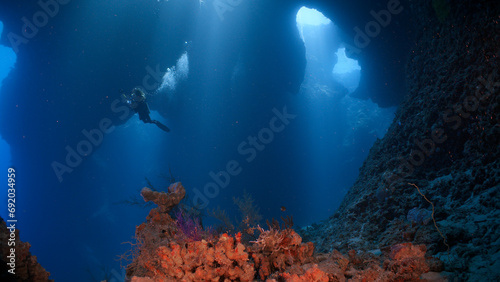 A SCUBA Diver explores inside a massive underwater cavern © Lightning Strike Pro