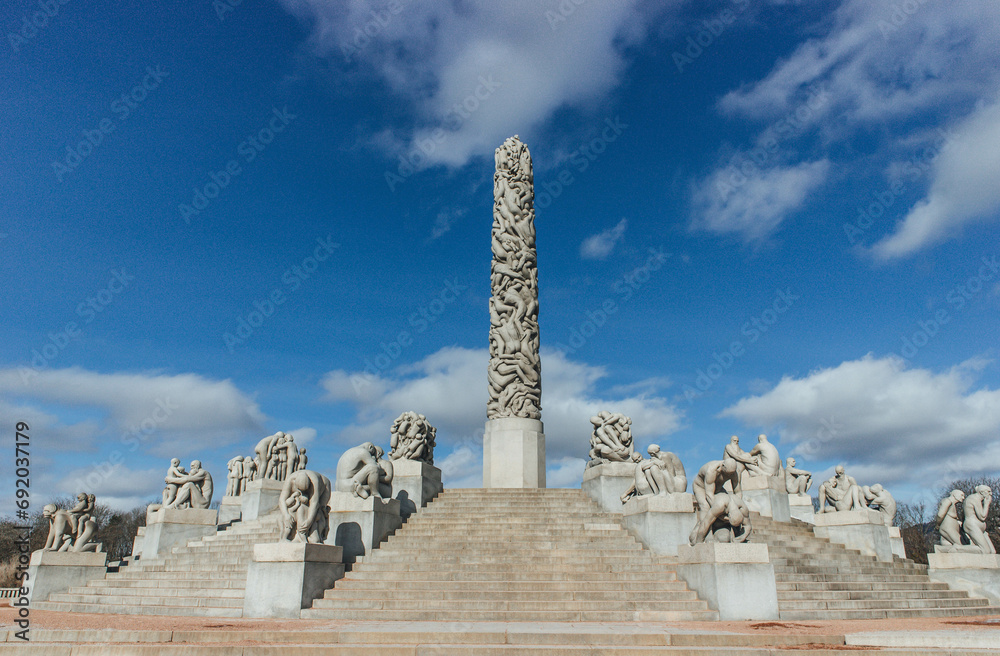 monument to the discoveries in nordic style architecture with human figures in different positions  and monolite 