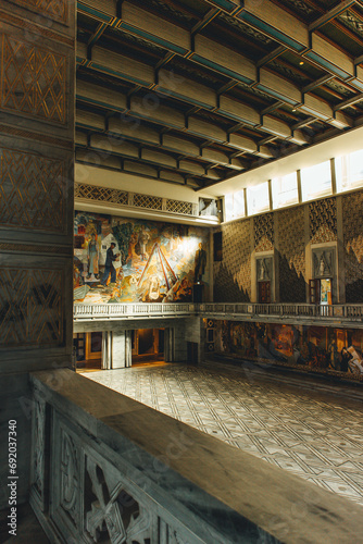 huge hall with norse nordic traditional paintings with beautiful light in town hall oslo