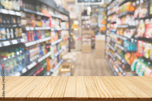 Empty wood table top with supermarket blurred background for product display