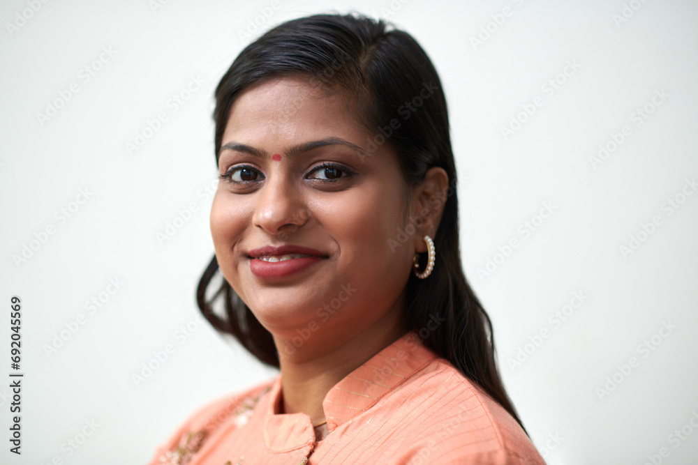 Face of smiling Indian woman with bindi on forehead looking at camera Face of smiling Indian woman with bindi on forehead looking at camera