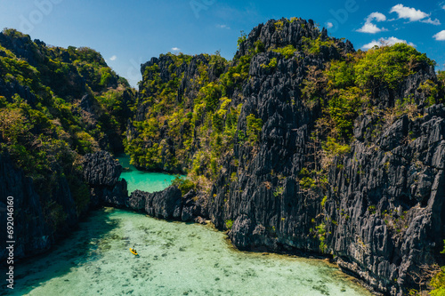 Secret lagoon in El nido. couple enjoying time in the crystal transparent water and kayaking. Concept about traveling and nature photo