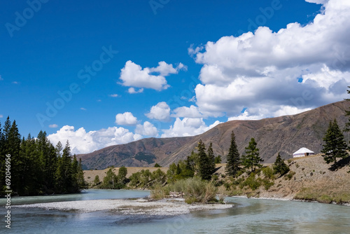 Beautiful mountain landscape on a sunny summer day in a forest-steppe area. A yurt near the river.
