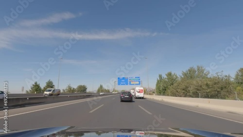 First person view, FPV, from dashcam of car driving towards Madrid from Granada in Andalusia, Sierra Nevada Mountains, Spain, Europe. Road trip video in POV, with bright, sunny, blue sky photo