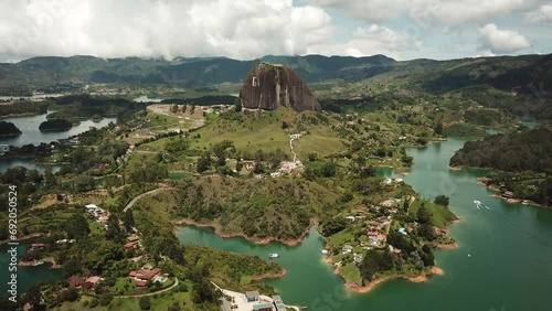 Aerial drone footage of El Penon de Guatape near Medellin in Antioquia, Colombia. Large and unique alone rock with stairs to the top, touristic place. Big stone in Colombia. High quality 4k footage. photo