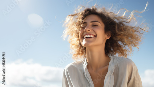 A Blonde woman breathes calmly looking up isolated on clear blue sky