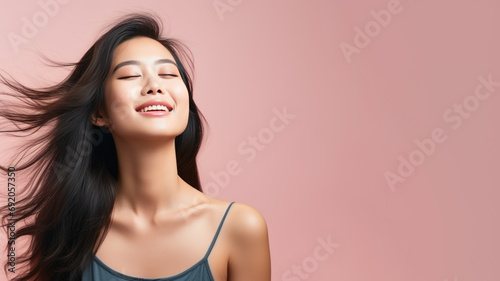 A asian woman breathes calmly looking up isolated on pastel background