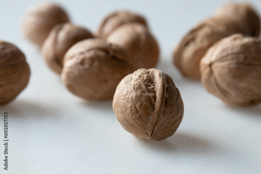 Walnuts on a white background. Close-up, selective focus. Walnuts on a white background. Close-up, selective focus.