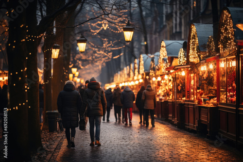 Christmas market on the evening street and holiday lights. Christmas shopping, festive mood. Silhouettes of people.