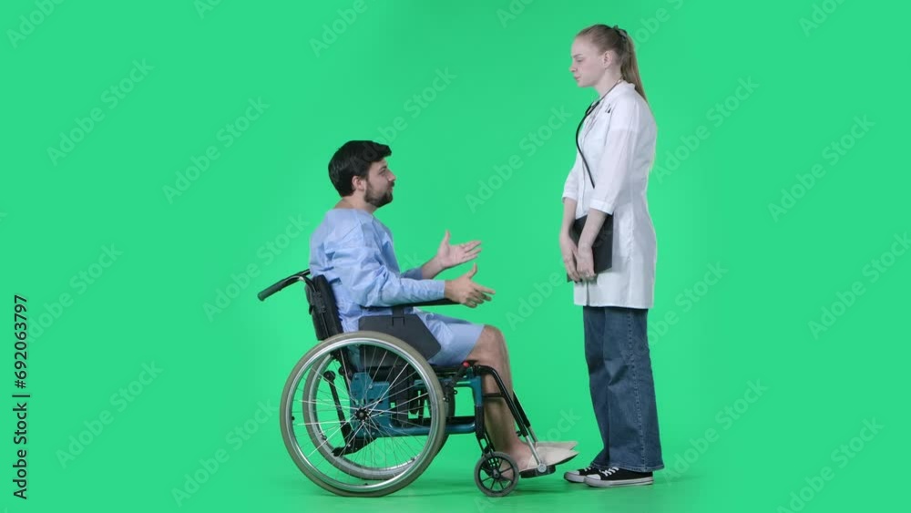 Man in wheelchair nurse checking his legs, touching feet, asking questions about feelings. Isolated on chroma key green screen. Man in wheelchair nurse checking his legs, touching feet, asking questions about feelings. Isolated on chroma key green screen.