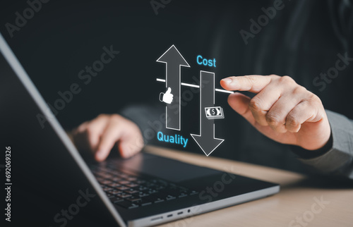 Quality control, Businessman adjusting level of quality with up arrow to balance cost with down arrow for business strategy management. Control cost budget and improve quality of product and service.