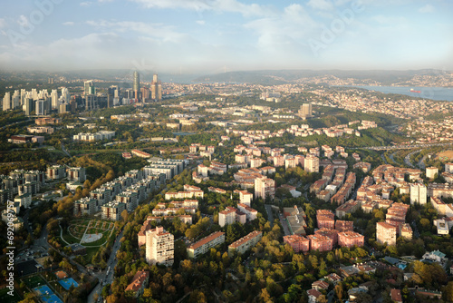 Aerial view  to a modern city with skyscrapers, dormitory area and parks.
