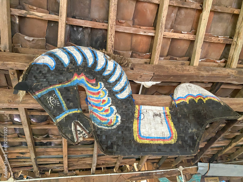 Kuda Lumping or Flat Horse made from woven bamboo hanging on traditional javanese joglo house ceilings. Traditional dance from Ponorogo, Java, Indonesia. photo