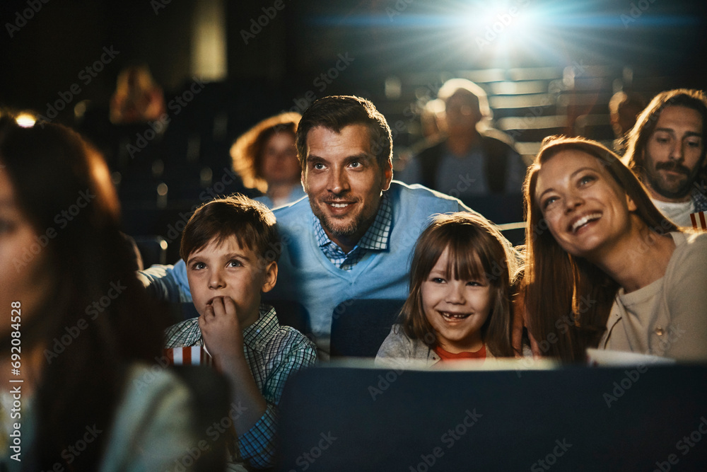 Happy young family in the cinema watching movie Happy young family in the cinema watching movie