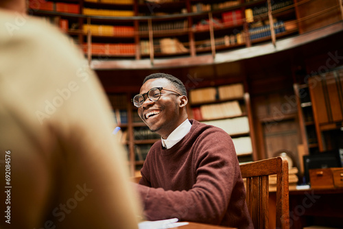 Smiling young man student in college library photo