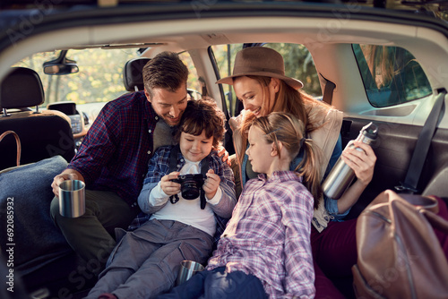 Happy young family in car road trip photo
