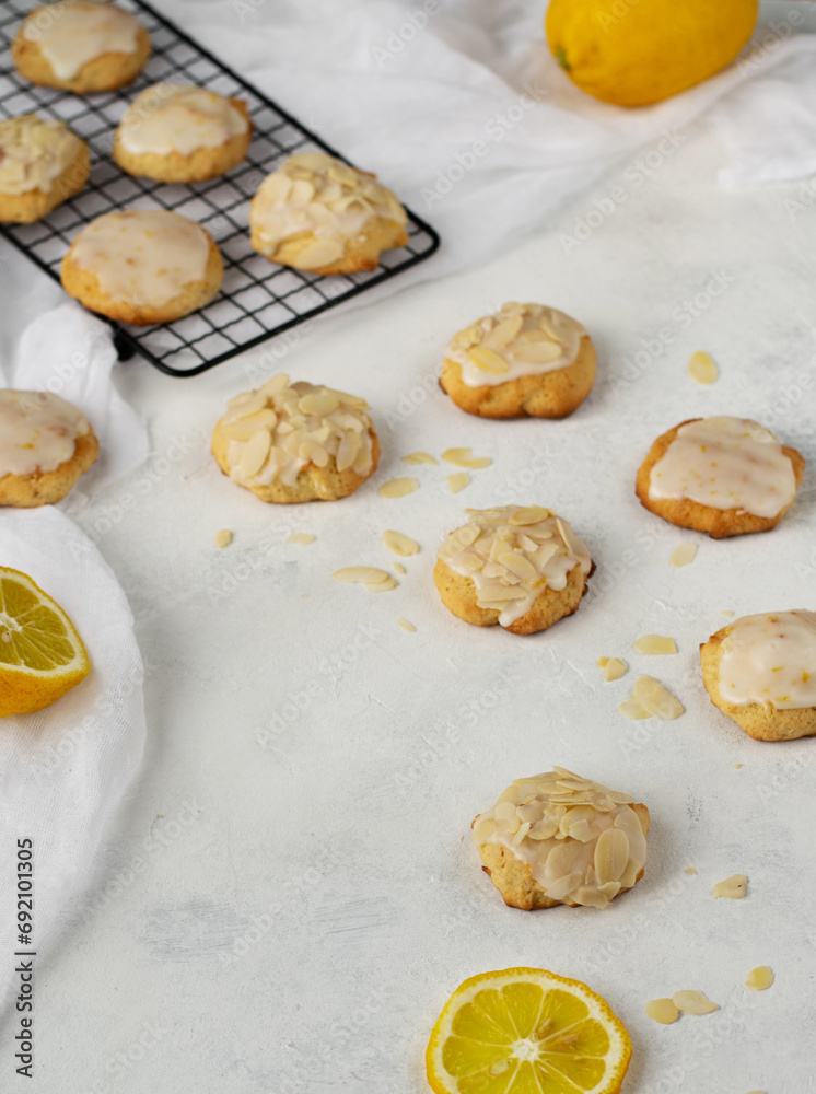 Homemade Italian lemon shortbread cookies with glaze and almond. Shortbread citrus biscuits on white stone background Homemade Italian lemon shortbread cookies with glaze and almond. Shortbread citrus biscuits on white stone background