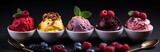 five spoon selections with four varieties of ice cream on one side and berries