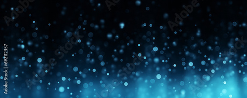 Blue motes of light in a colored glowing abstract gradient for banner copy space  digital material texture on black background