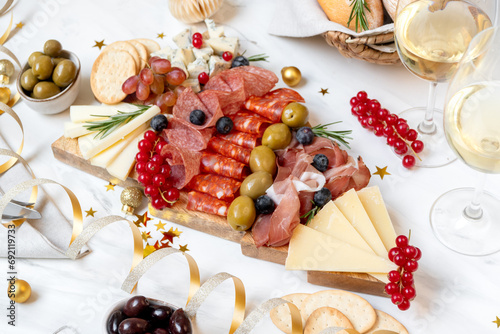 Photography Party charcuterie board italian food antipasti prosciutto ham, salami and cheese appetizers served in the shape of a Christmas tree