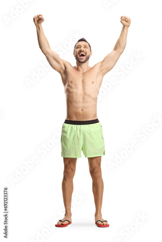 Young man in swimming shorts gesturing happiness photo