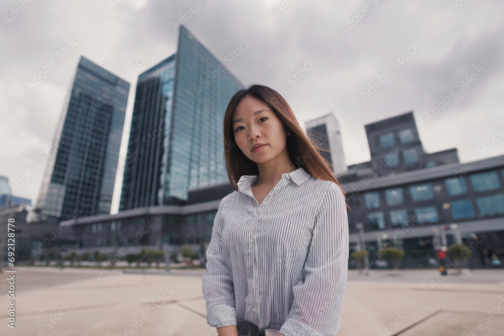 young adult woman, in front of an office complex