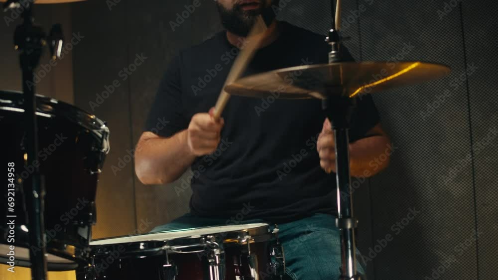 Expressive drummer young man professionally playing on dums in studio room close-up. Rock metall music artist Expressive drummer young man professionally playing on dums in studio room close-up. Rock metall music artist
