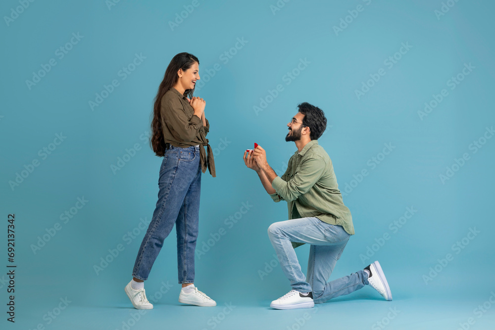 Happy indian man making his girlfriend marriage proposal - obrazy, fototapety, plakaty 