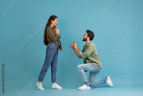 Happy indian man making his girlfriend marriage proposal