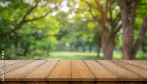 empty wood table top and blurred green tree in the park garden background can used for display or montage your products