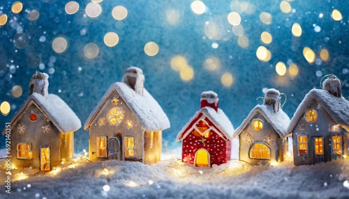 cute small houses christmas background with copyspace festive blue snowy background with christmas lights blurred background