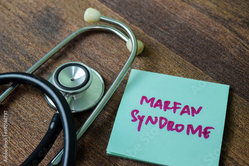 Concept of Marfan Syndrome write on sticky notes with stethoscope isolated on white background. photo