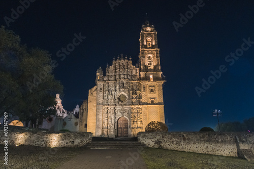 Temple of San Francisco Javier in the magical town of Tepotzotlán at night with its lighting, with the stars behind, with baroque architecture. photo