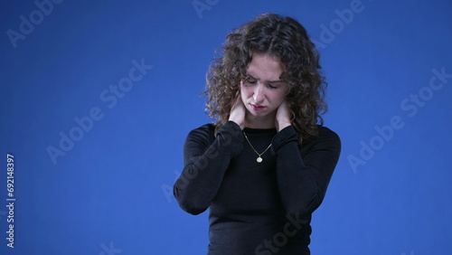 Εκτύπωση καμβά Stressed young woman rubbing neck trying to appease mental anguish while standin