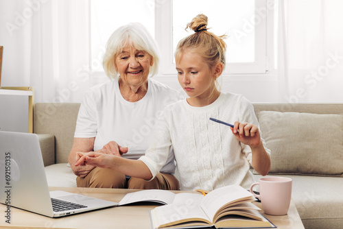 Bonding child selfie education grandmother family hugging granddaughter laptop smiling togetherness sofa