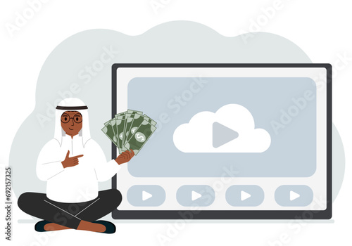 A man holds paper banknotes in his hand, next to a computer with a video. Freelancer, earning money, working on the Internet, training, coaching, business, remote work.