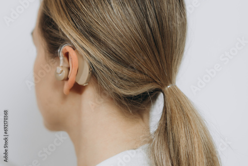 The hearing aid in the girl's ear