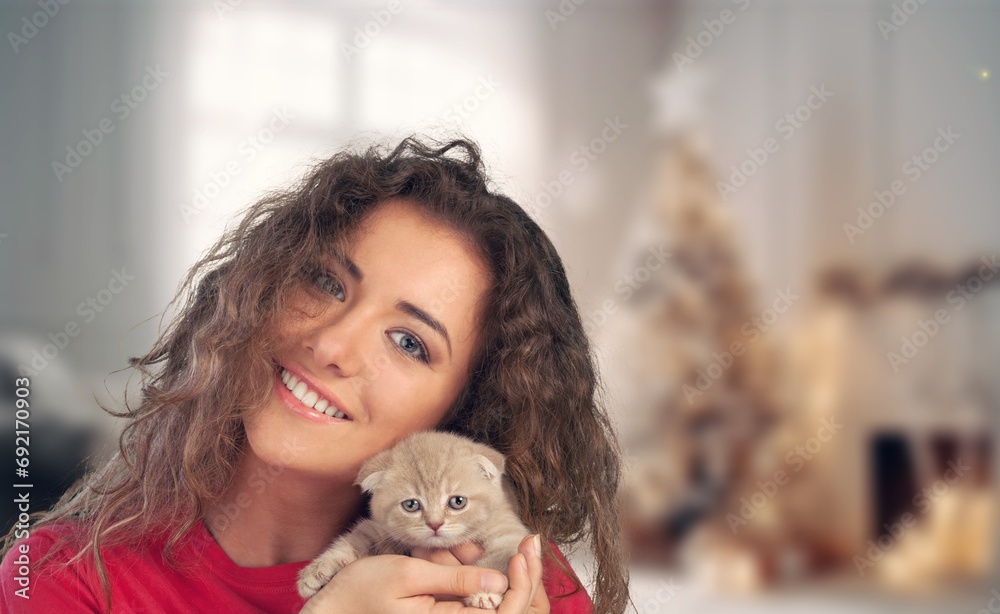 Happy young woman hugging small cute cat Happy young woman hugging small cute cat
