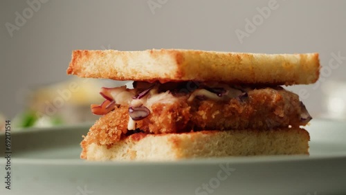 American deep fried fish or chicken sandwich with ham meet cuts in restaurant, cooking Famous thick cut sous vide beef sandwich on restaurant cafe kitchen.  photo