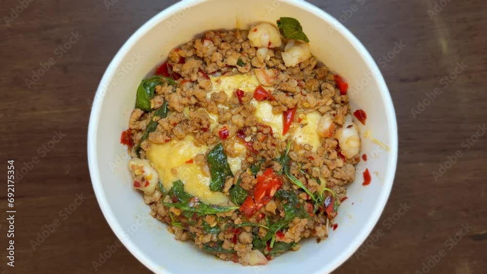 Thai basil pork with scramble egg in a bowl