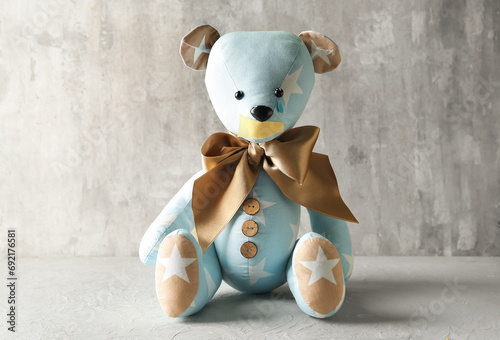 Toy bear with taped mouth a...