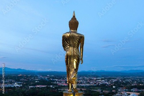 Standing Buddha statue overlooking Nan town  mountains and valley in Nan  North Thailand. View from Wat Khao Noi.