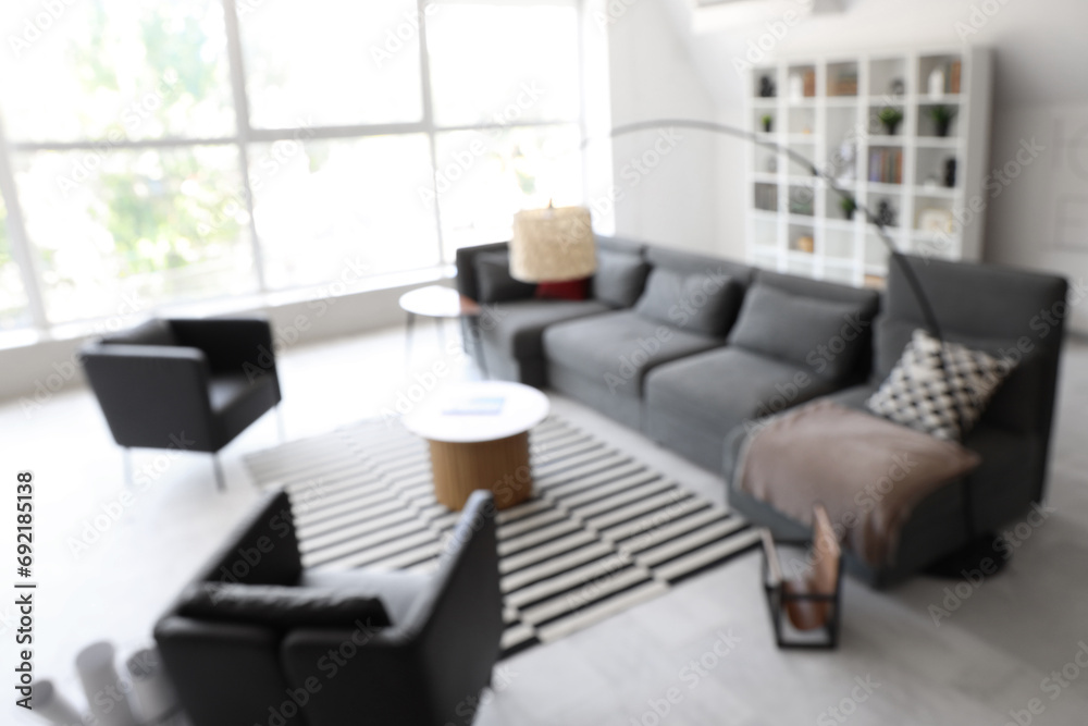 Fototapeta premium Blurred view of modern living room with stylish sofa