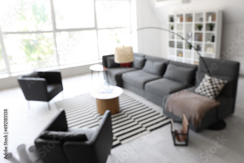 Blurred view of modern living room with stylish sofa
