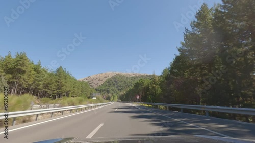 First person view, FPV, from dashcam of car driving in the beautiful Spanish countryside towards Seville, Andalusia, Spain, Europe. Road trip video in POV, with bright, sunny, blue sky photo